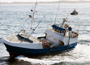 Fishing boat and tug boat at the sea