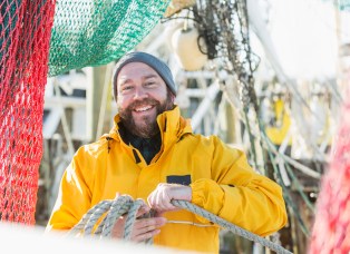 Man working on commercial fishing vessel
